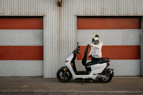 Rider on a white Zero LS1 beside a roller door