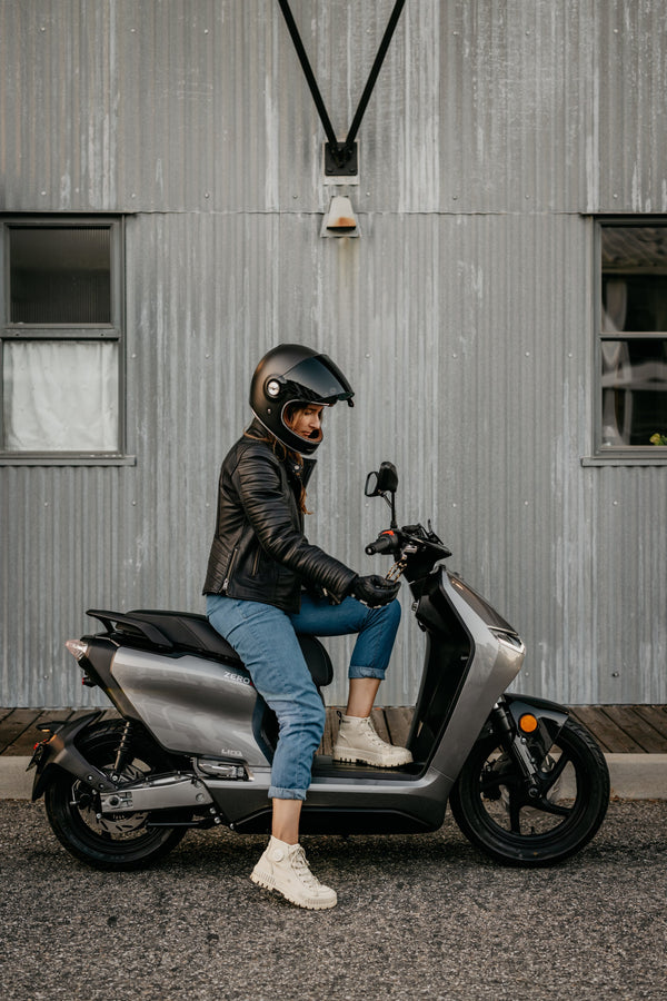 Rider seated on a grey Zero LS1 outside a building