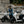 Two Zero LS1 riders beside a stone wall