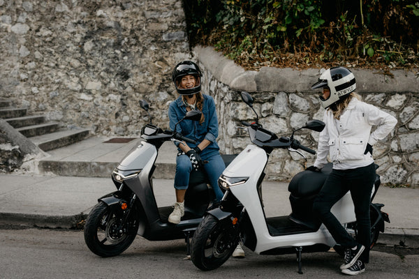 Two Zero LS1 riders beside a stone wall